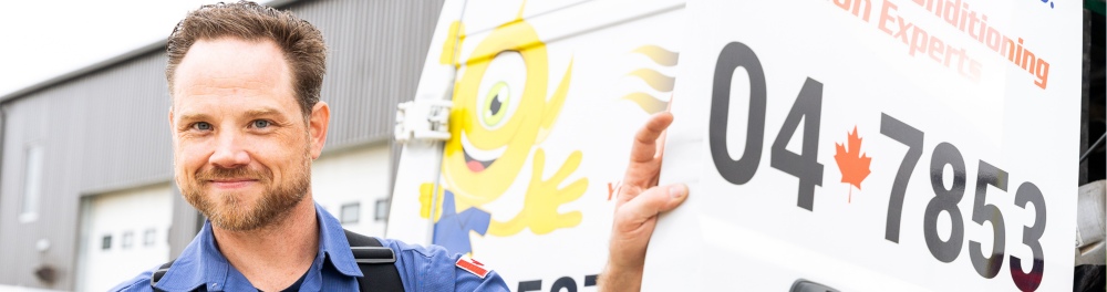 A smiling Always Plumbing & Heating technician hops out of his service truck.